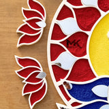 Decorative wall art with red, white, and blue design on a wooden background